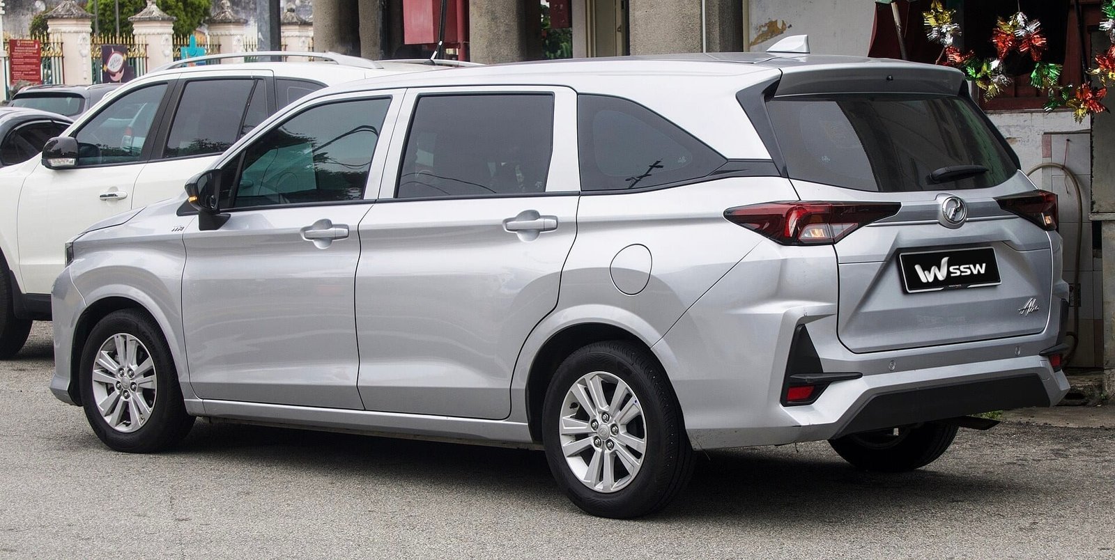 2024 Perodua Alza 1.5 X MPV in silver, rear three-quarter view parked on a street in Penang, Malaysia, in daylight