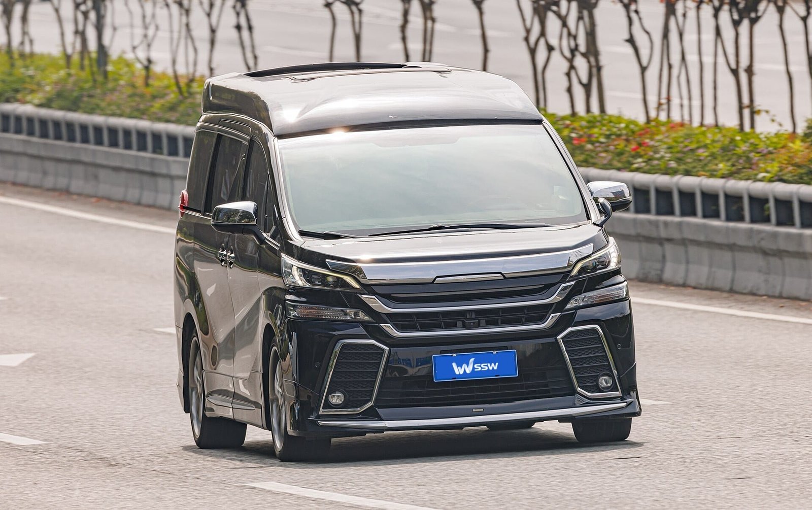 Black Toyota Alphard (AH30), front three-quarter view on a city road in Shenzhen, China, in daylight